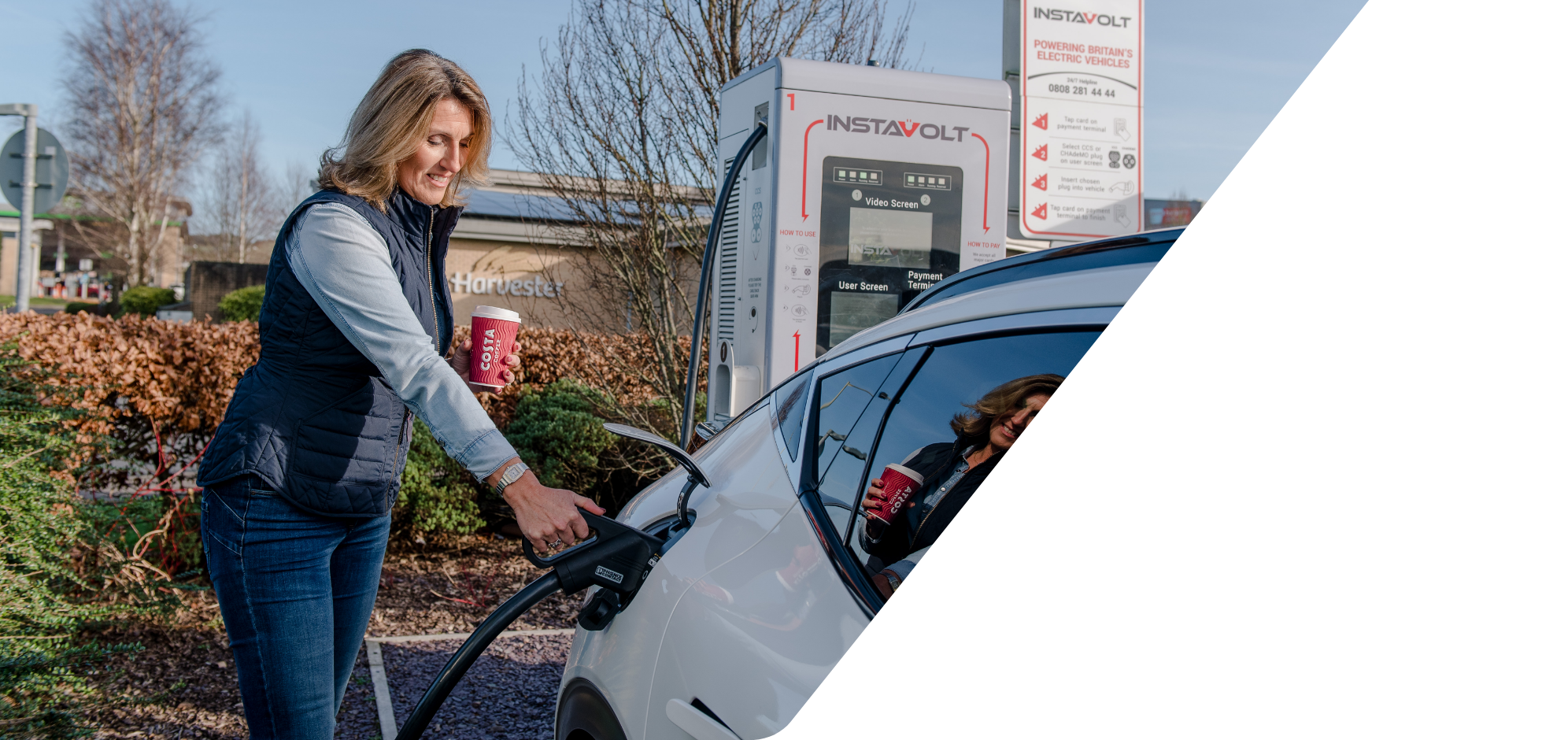 Woman charging car using Instavolt charger