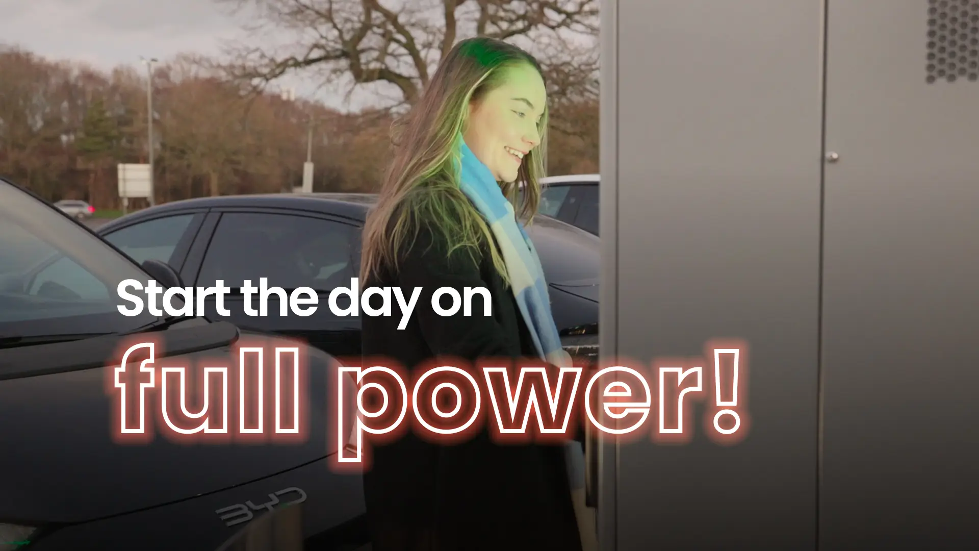 Woman charging her electric vehicle at an InstaVolt station