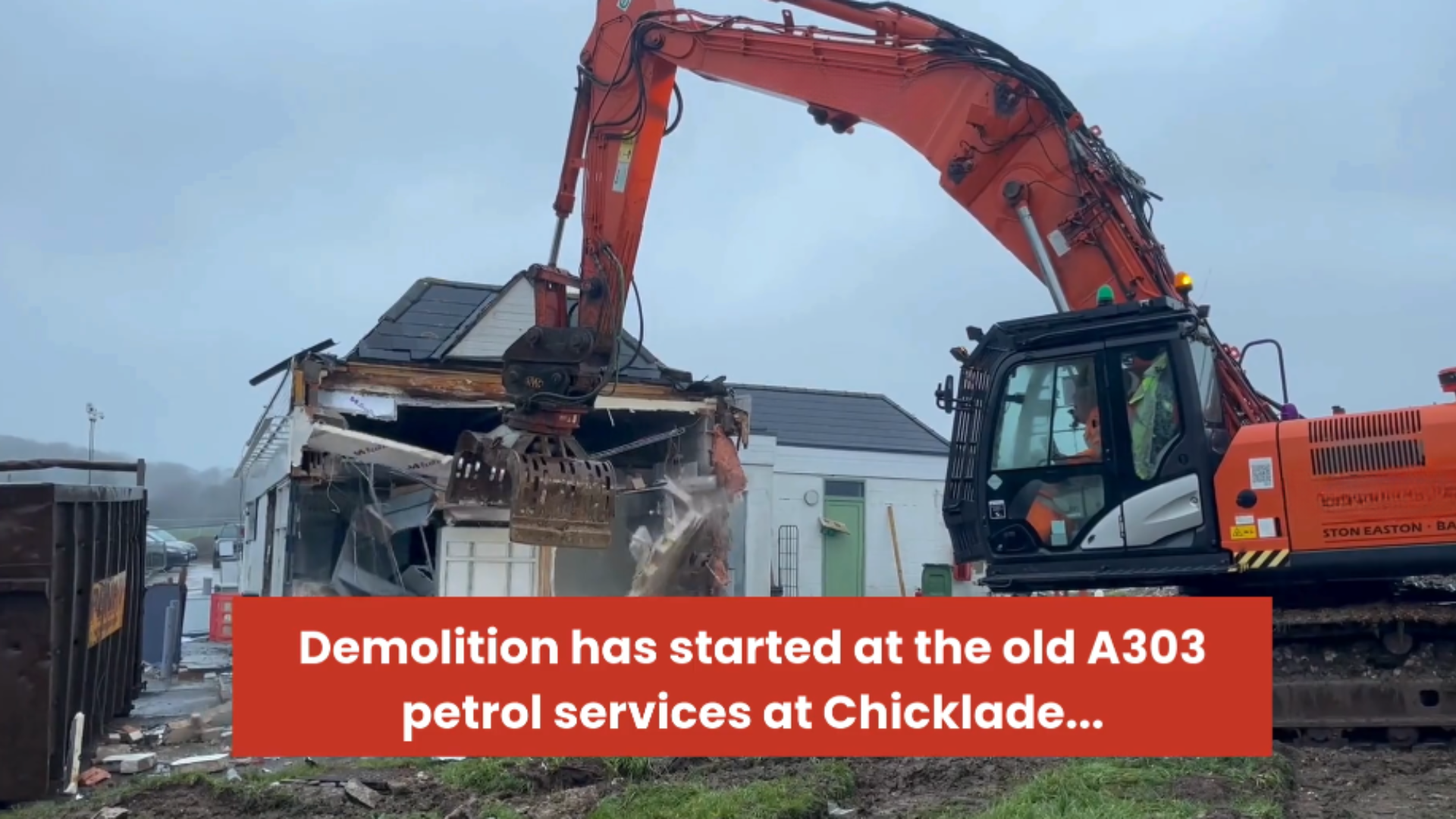 Digger demolishing old petrol station