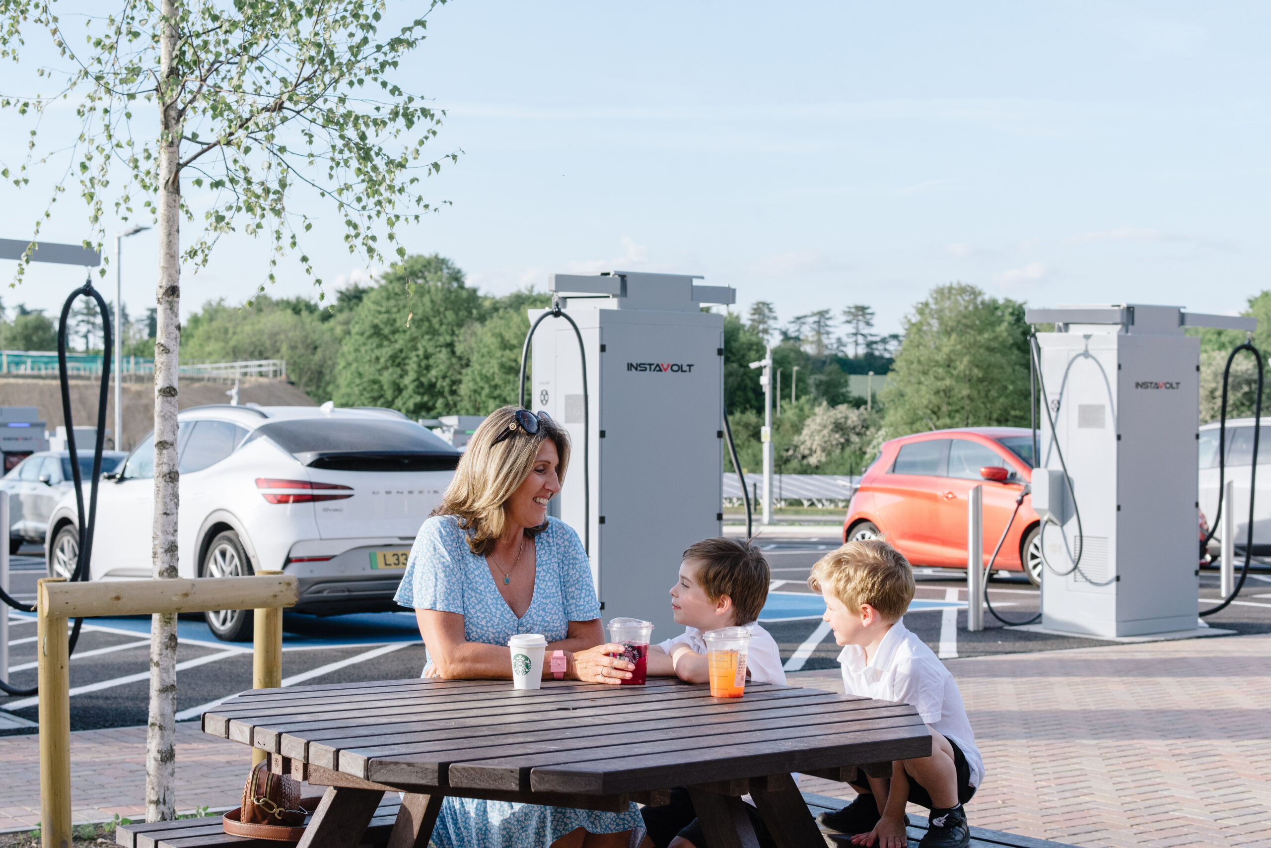 Family at InstaVolt EV charging site