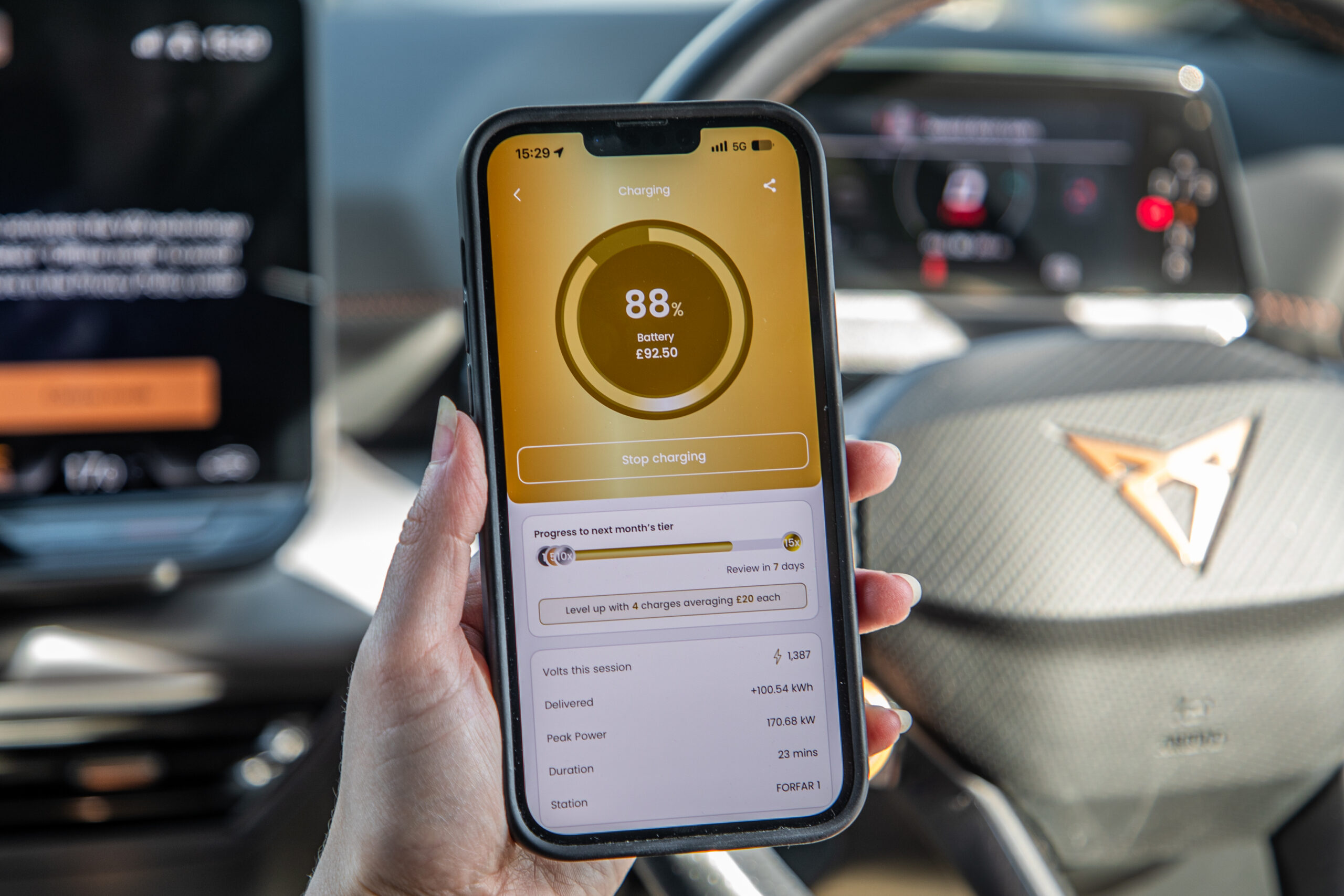 An iPhone screen showing the InstaVolt Miles reward programme at Gold tier while someone charges in their car
